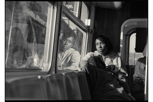man riding in bus wearing hoodie